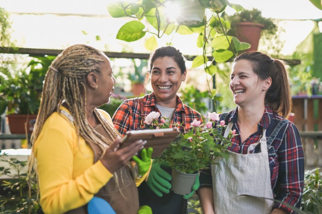 Multiracial,Women,Having,Fun,Together,Working,Inside,Garden,Greenhouse